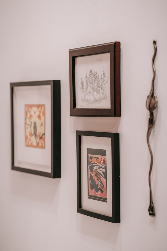 team-02 Curated art and decor pieces elegantly displayed in a minimalist indoor setting.