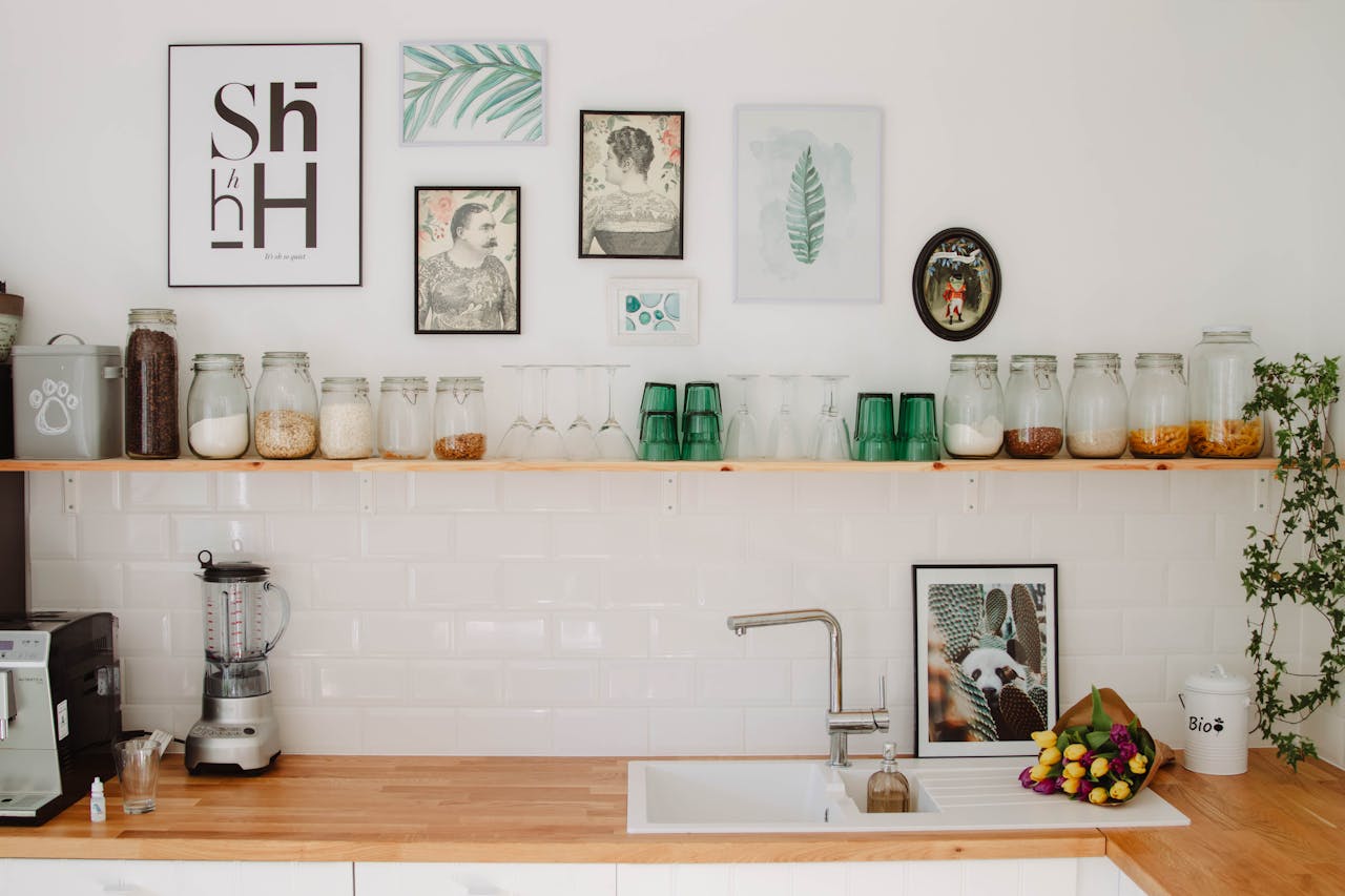 services-01 Contemporary kitchen in Estonia featuring wooden shelves, decor elements, and glass jars above a sink.